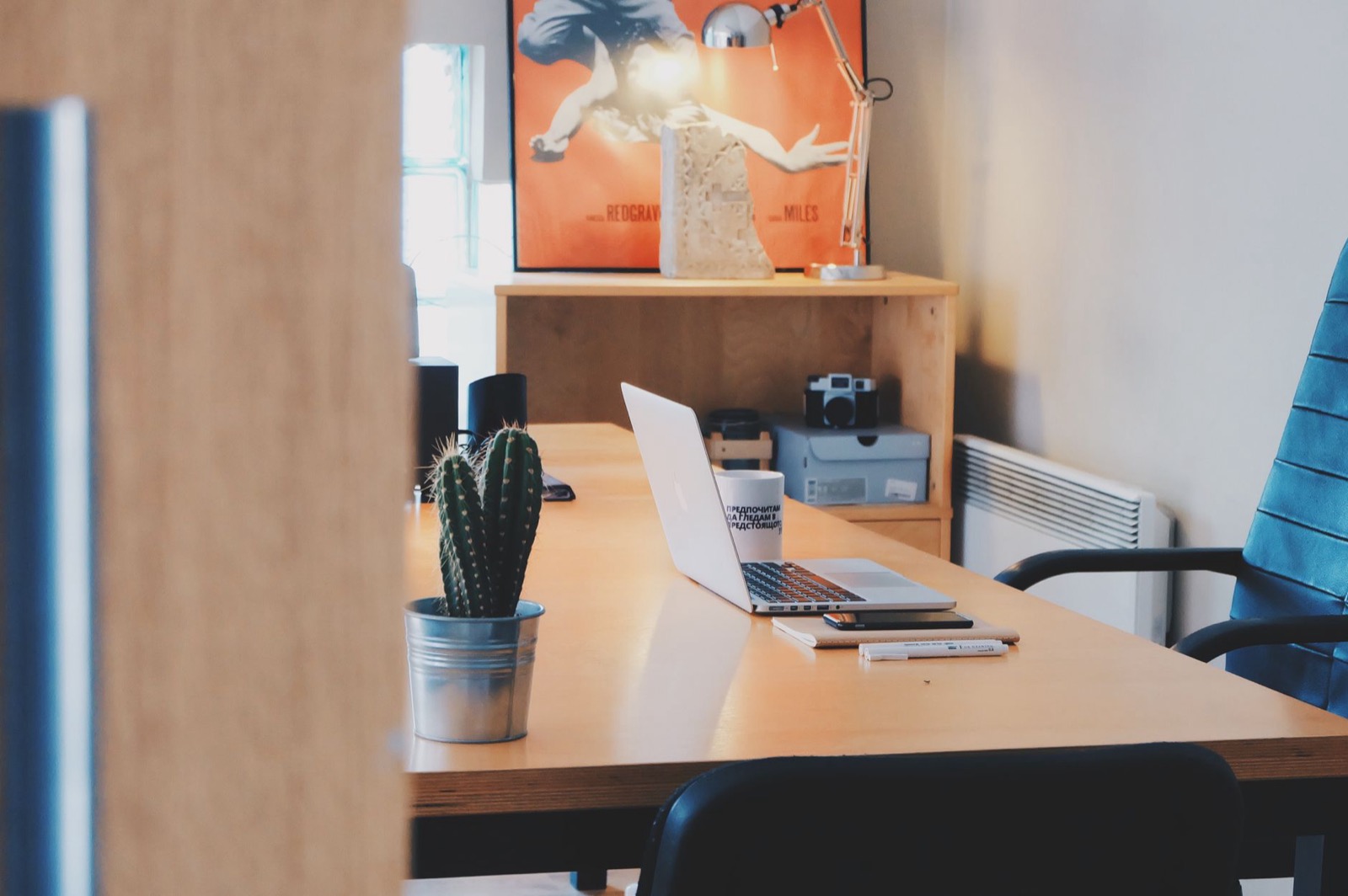 A clean web designer's workspace with a laptop — the platform decision happens before the pixels